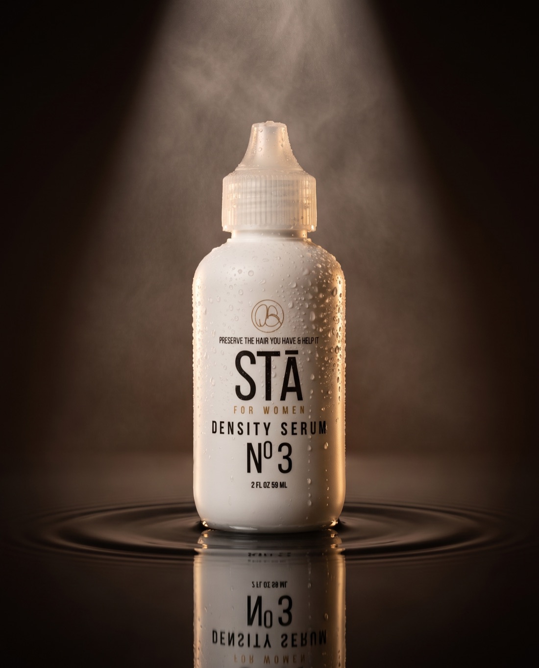 STĀ For Women Density Serum Nº3 dropper bottle beaded with water under a spotlight