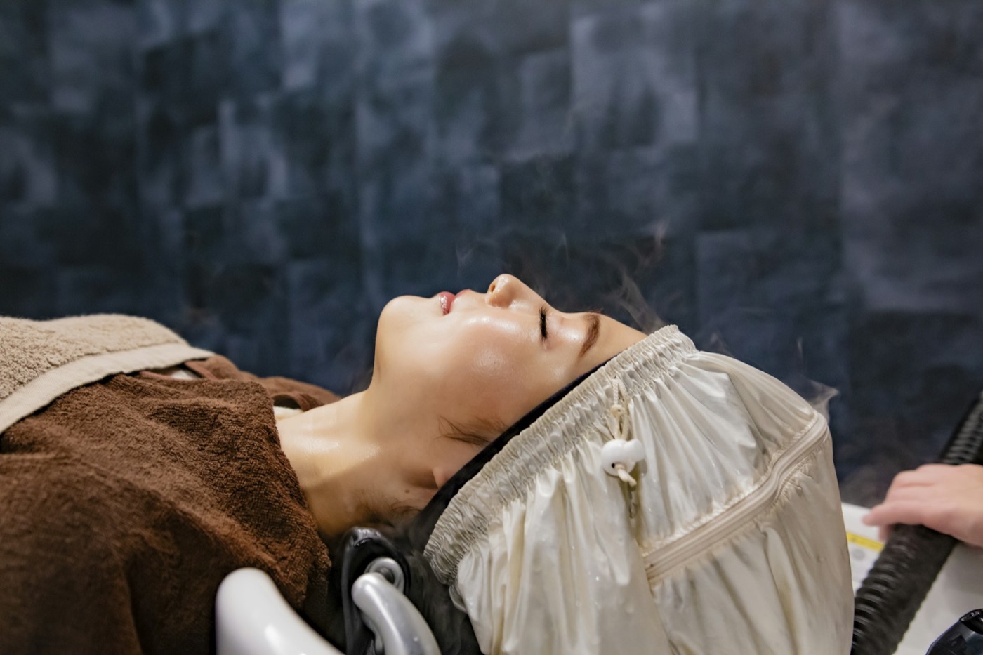 A restorative scalp treatment with therapeutic steam