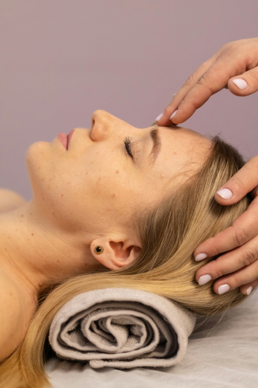 A trichologist assessing a client scalp during a hair and scalp analysis